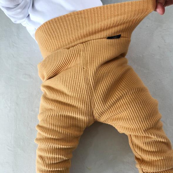 Unisex infant ribbed cotton pants with soft fleece lining, designed for maximum toddler comfort.