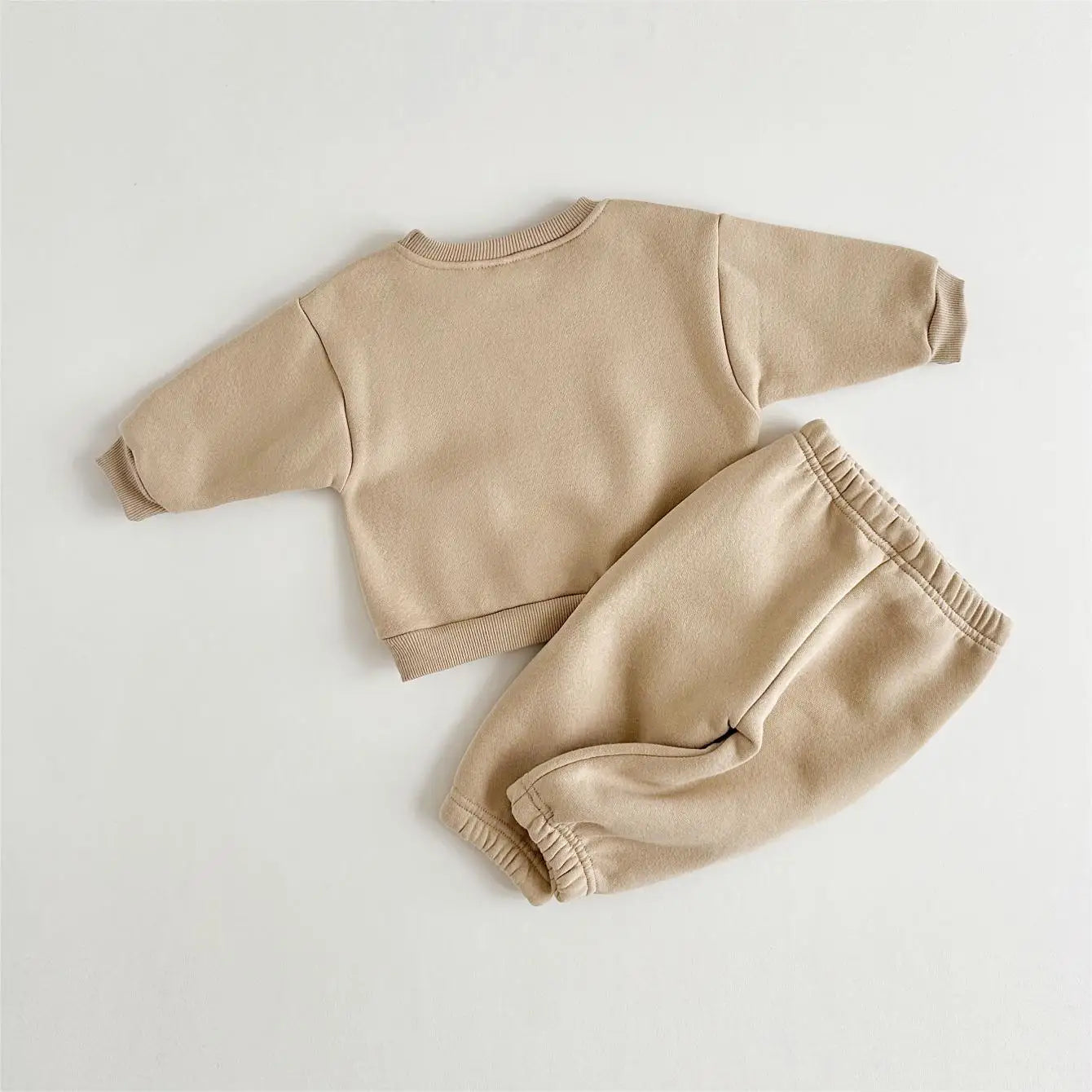 Close-up of floral embroidery detail on a Girls' Warm Winter Tracksuit Set, pink cotton