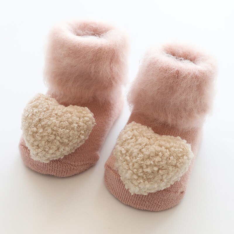 Newborn winter socks, fur-lined and anti-slip, ensuring warmth and secure footing for little ones.