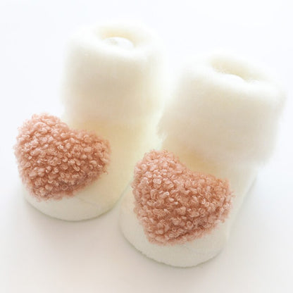 Plush fur-lined baby winter socks with anti-slip soles, ideal for keeping tiny feet toasty.