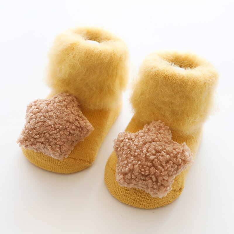 Infant anti-slip socks with a thick fur lining, designed for warmth and safe play at home.