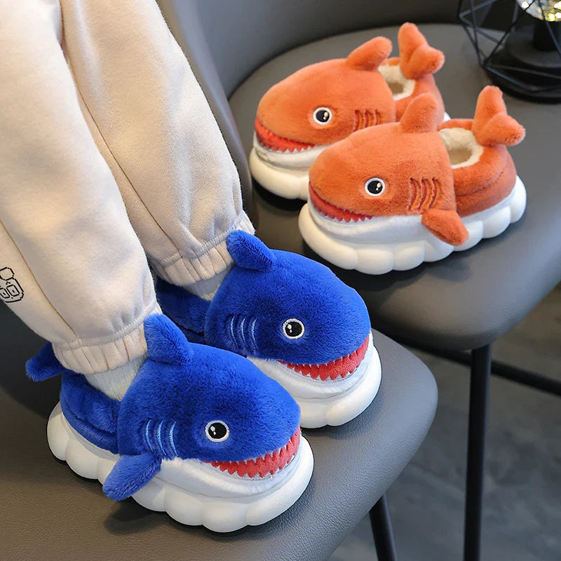 Cozy kids' cotton slippers with a fun cartoon shark design, providing warmth and a non-slip grip.