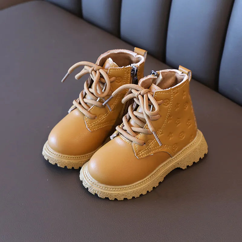 Pair of brown kids' winter boots, plush-lined for warmth, ideal for cold weather