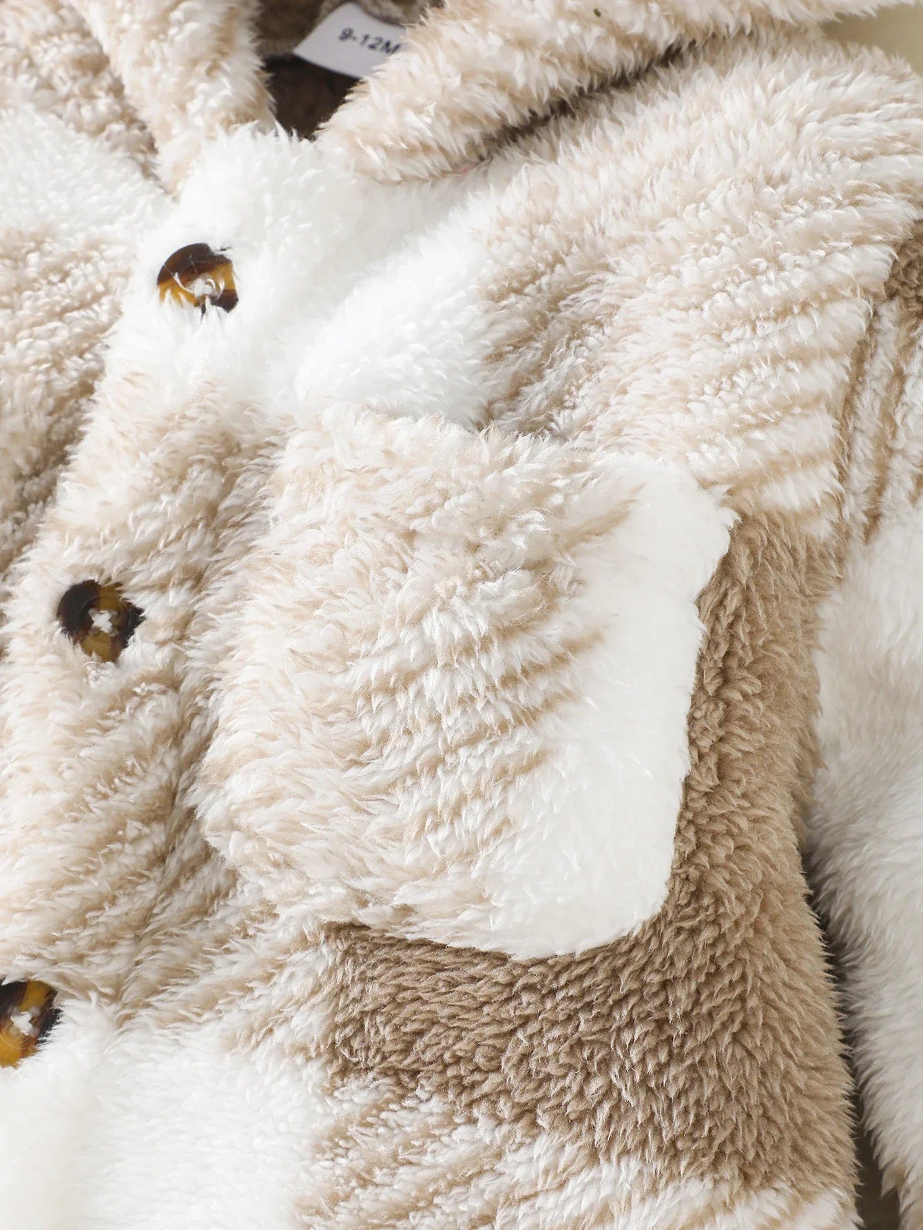 Infant winter jumpsuit featuring a stylish plaid print and a warm hood.
