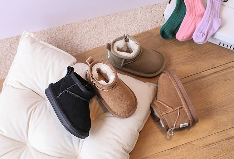 Close-up of children's warm brown ankle boots, showing a soft faux fur lining for winter.