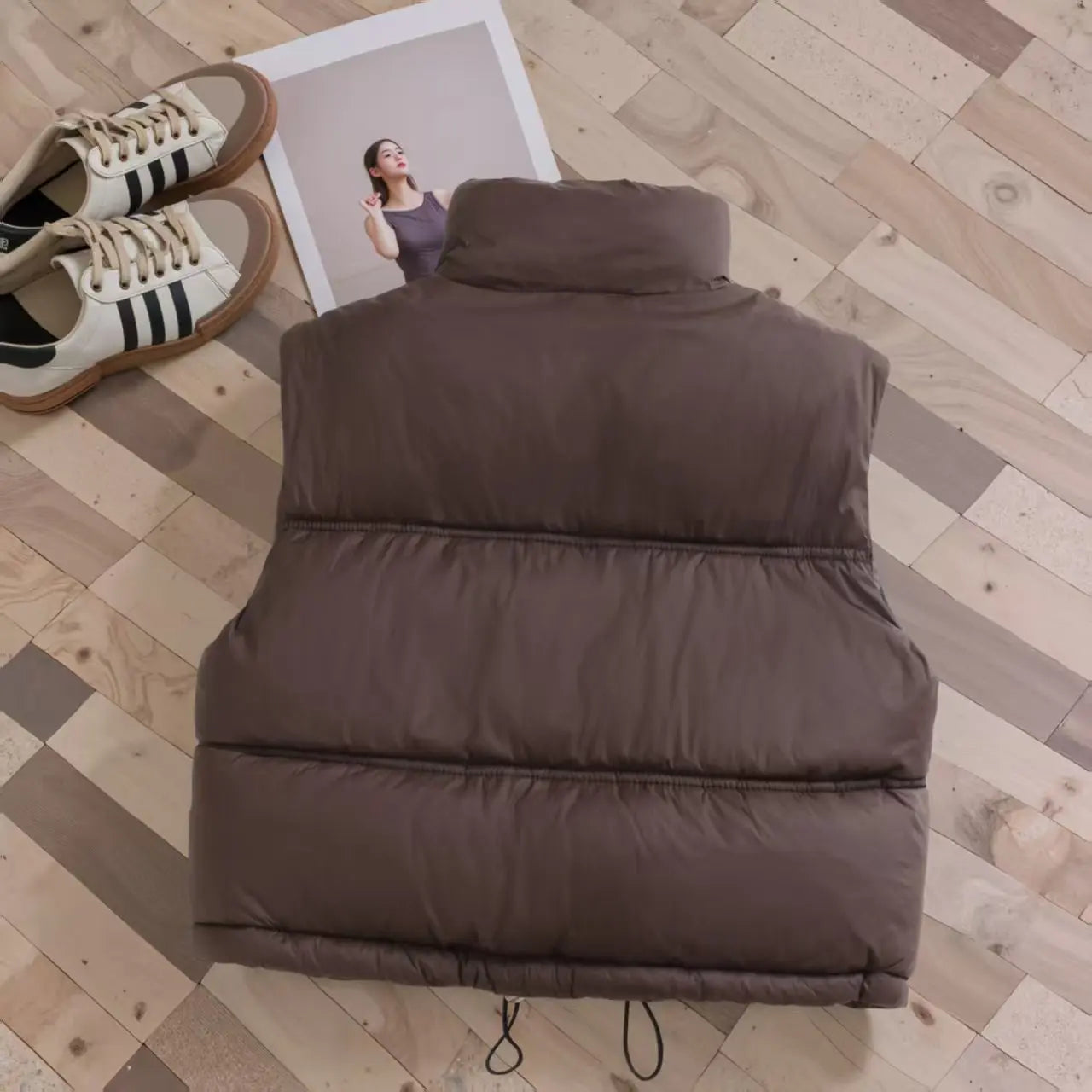Child modeling a lightweight black puffer vest, ideal winter bodywarmer & kids' outerwear