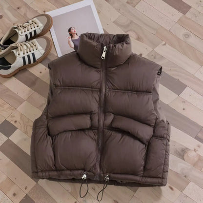 Collection of colorful kids' puffer vests on display, warm winter bodywarmers for boys & girls