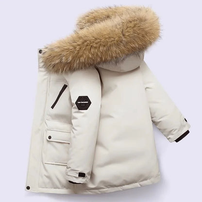 Little girl smiling in a pink padded waterproof winter coat, cozy and fashionable outerwear.