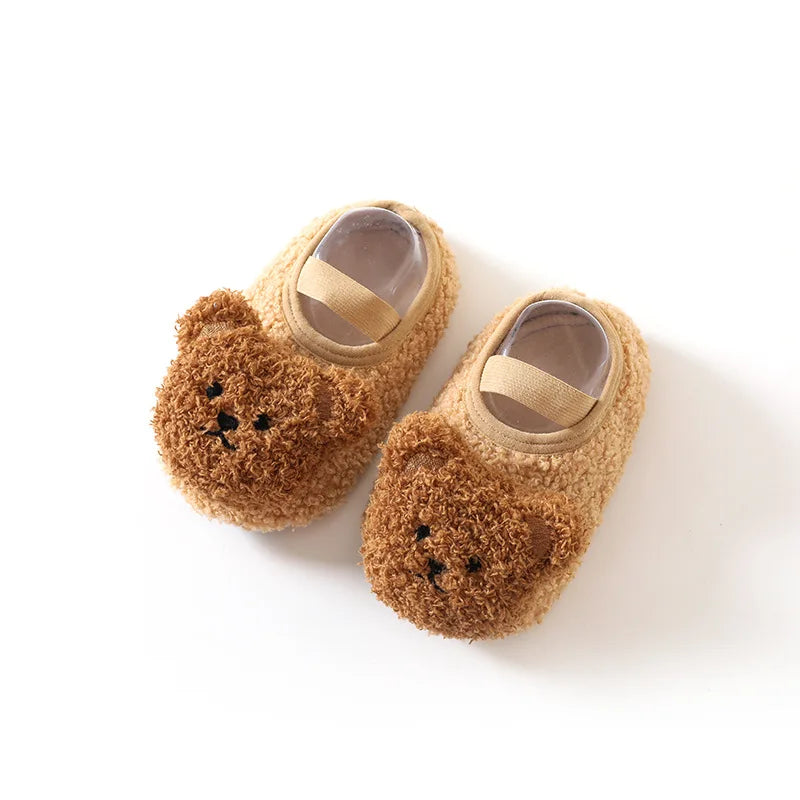 Soft, warm children's slippers with an adorable bear face and durable non-slip grip.