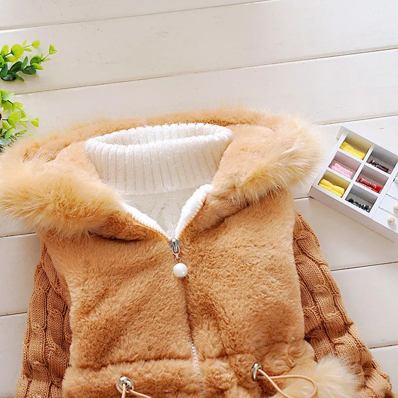 Girls' winter coat, plush and soft, with a focus on the zippered front and hood details.