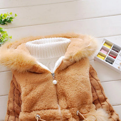 Girls' winter coat, plush and soft, with a focus on the zippered front and hood details.