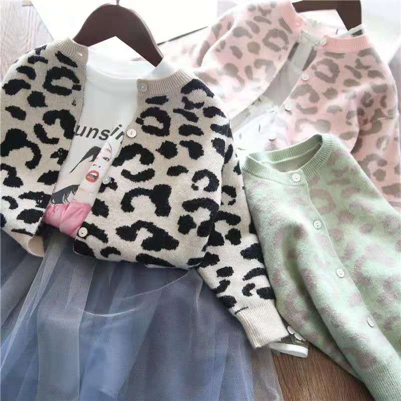 Close-up of a leopard print toddler cardigan, showing the soft fabric and button details, cute baby clothing