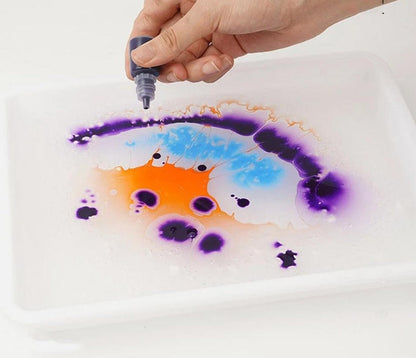 Kids using a water marbling paint art set to create colorful patterns, an educational and fun DIY craft