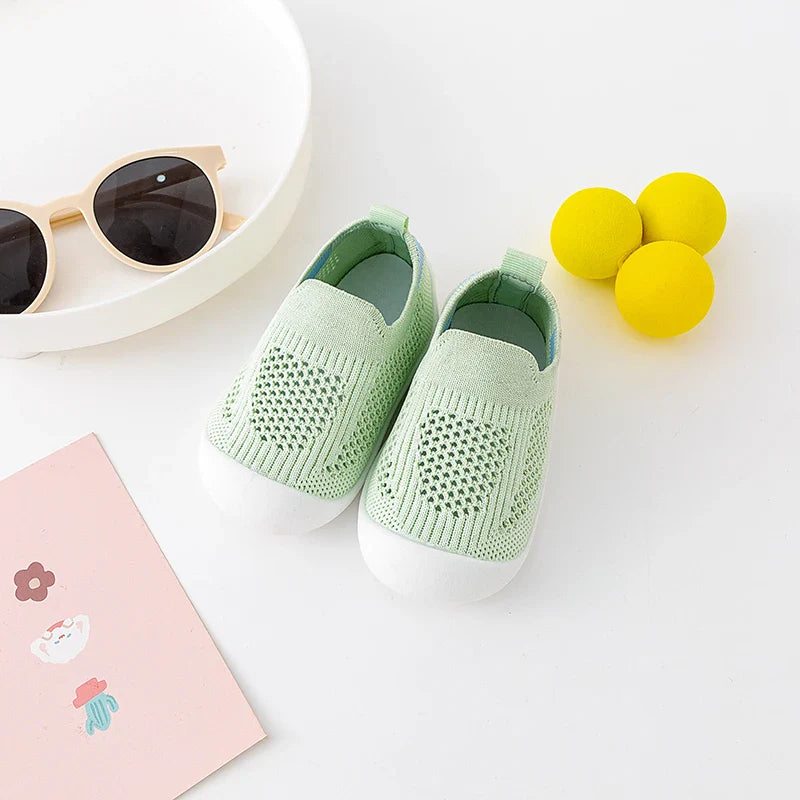 Side profile of pink baby breathable mesh shoes with a soft, flexible sole