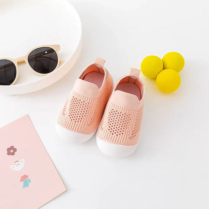 Toddler's feet in colourful mesh slip-on shoes, ready for outdoor play