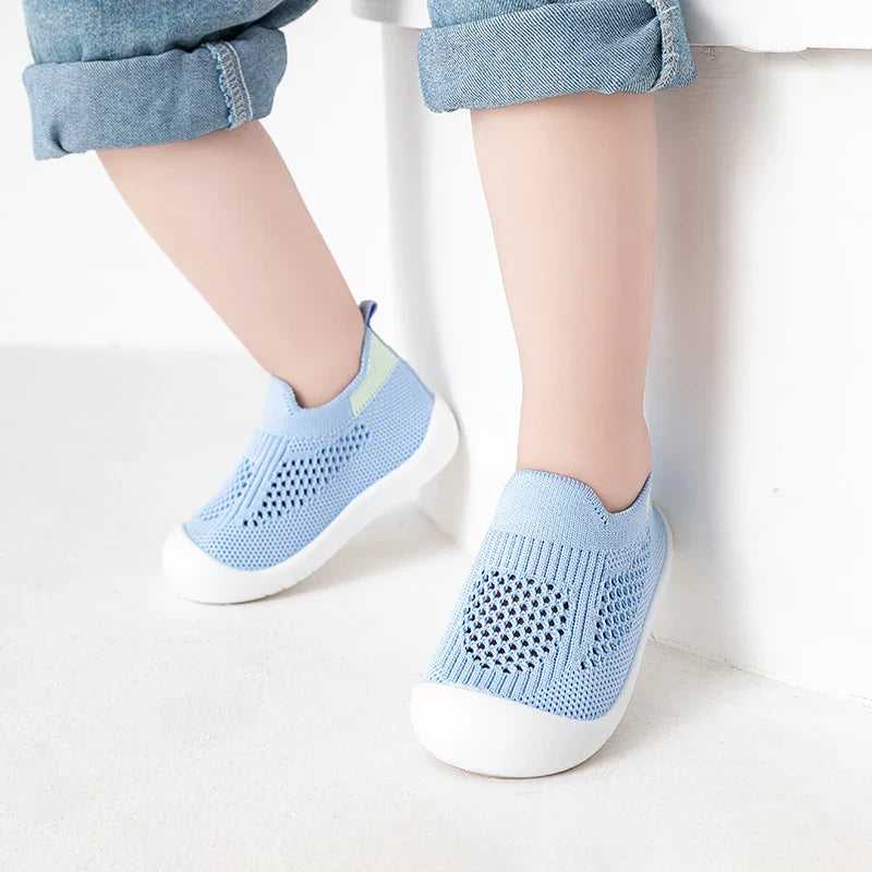 Orange infant summer shoes with mesh upper, providing airy comfort and support