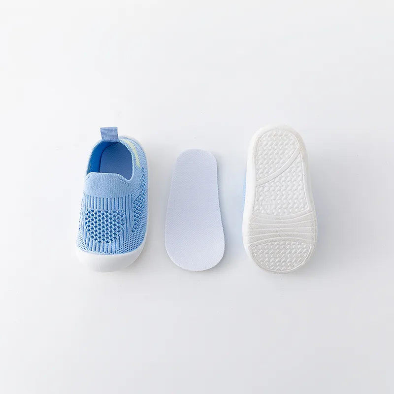 Back view of navy blue baby slip-on mesh sneakers, with pull tab for easy dressing