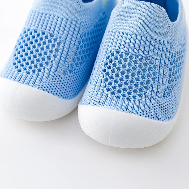 Red baby summer sneakers with soft mesh lining, keeping tiny feet cool