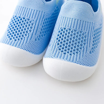 Red baby summer sneakers with soft mesh lining, keeping tiny feet cool