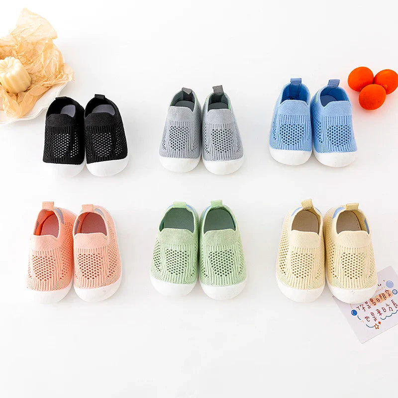 Close-up of the breathable mesh fabric on baby sneakers, showing comfort for tiny feet