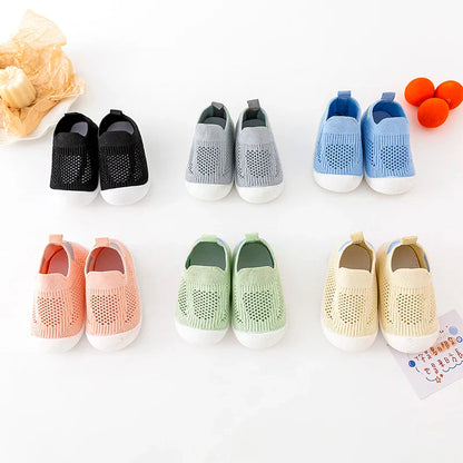 Close-up of the breathable mesh fabric on baby sneakers, showing comfort for tiny feet