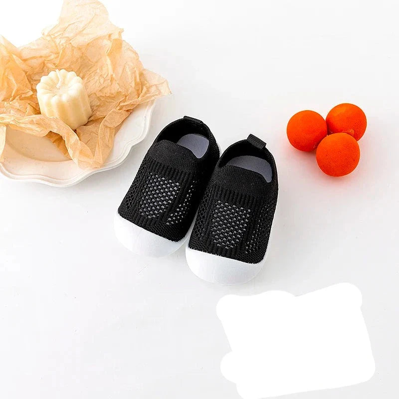 Green infant mesh footwear, designed for maximum breathability during summer