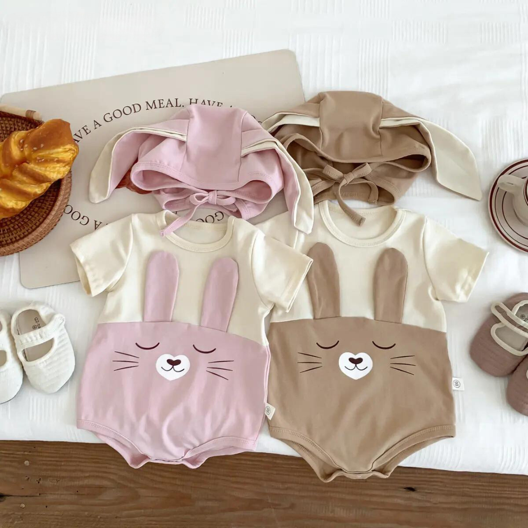 Closeup of soft white cotton baby bodysuit onesie with cap, perfect newborn outfit & baby gift.