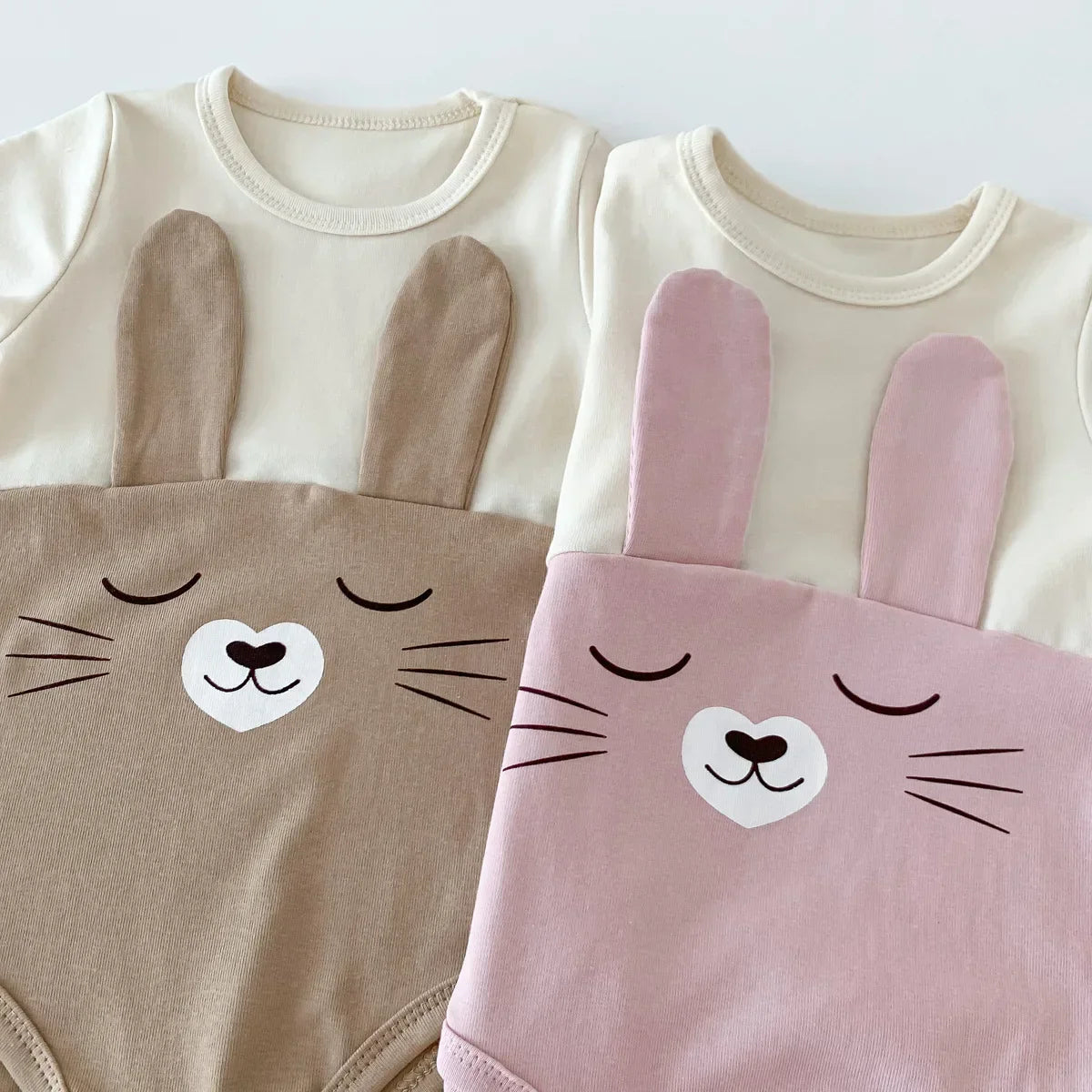 Adorable baby wearing white cotton bodysuit onesie and cap, comfortable baby fashion for infants.