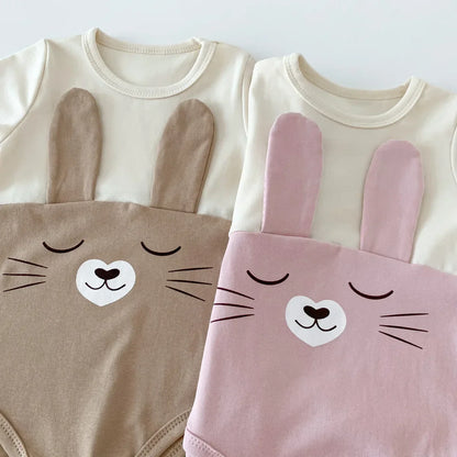 Adorable baby wearing white cotton bodysuit onesie and cap, comfortable baby fashion for infants.