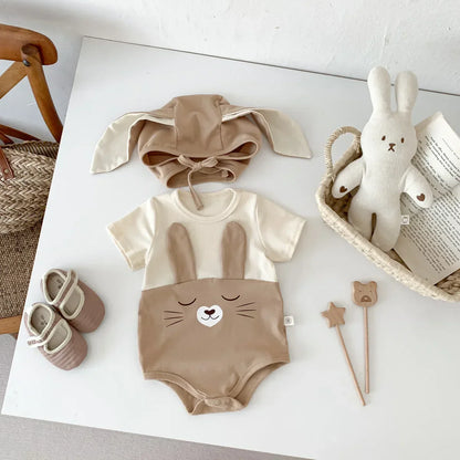 White baby cotton bodysuit onesie with snap closures and matching cap, breathable infant wear.