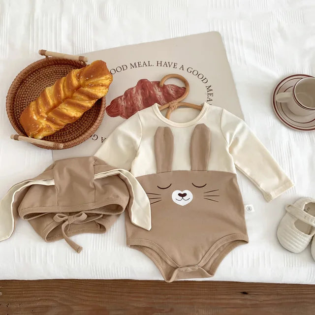Comfortable white cotton baby bodysuit onesie and cap for everyday infant wear, soft material.