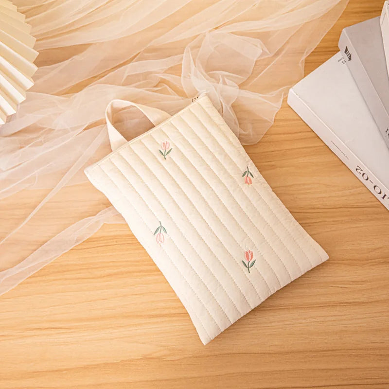 Embroidered baby nappy bag, showcasing high-quality stitching on soft cotton fabric