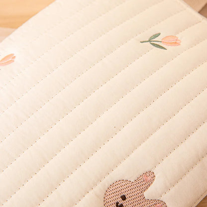 Embroidered cotton nappy bag, capturing its soft texture and elegant design, baby accessory