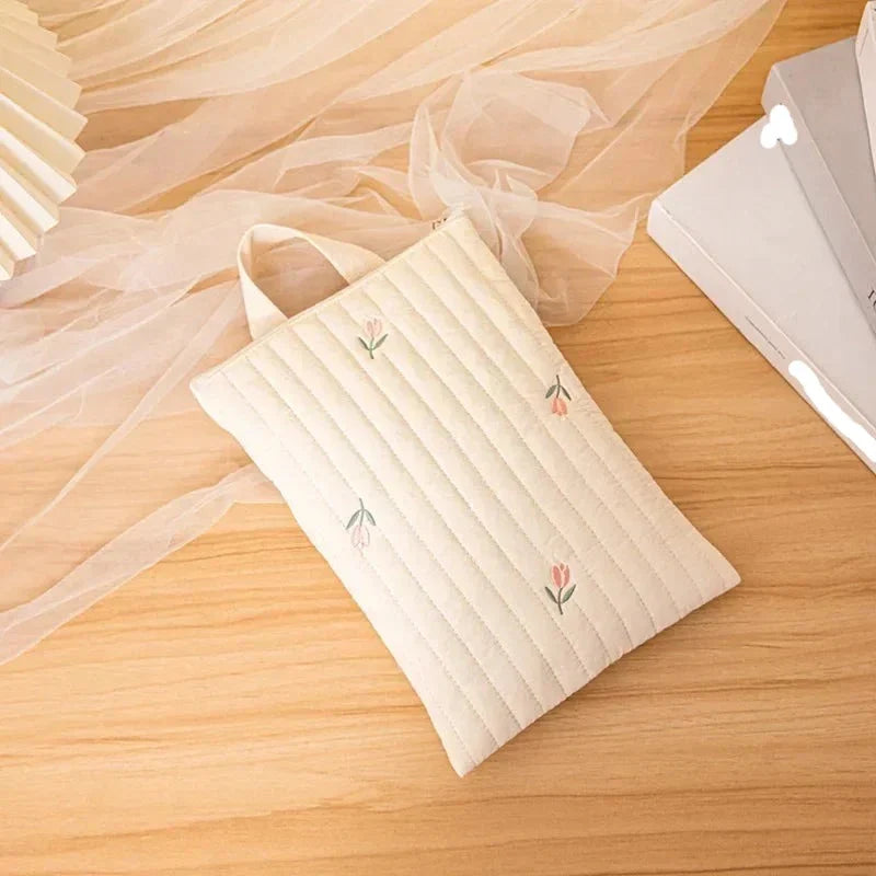 Back view of white cotton baby bag, displaying a convenient exterior pocket for quick access