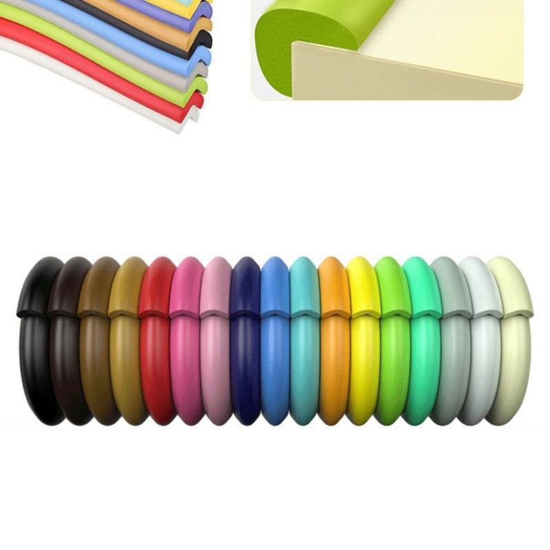 Child proofing foam edge guard in black, close-up on furniture corner for baby protection