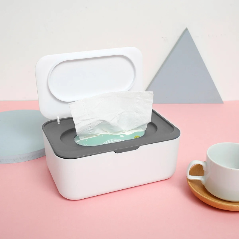 White baby wipes dispenser with airtight seal, keeps wipes fresh on changing table.