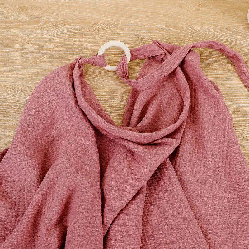 Newborn essentials: cotton muslin nursing cover and stroller blanket, soft fabric.