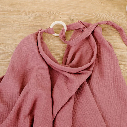Newborn essentials: cotton muslin nursing cover and stroller blanket, soft fabric.
