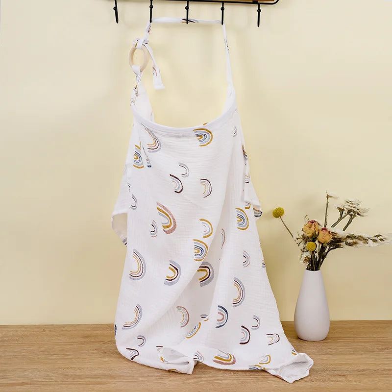 Breathable 100% cotton muslin cover folded neatly, texture visible, baby accessory.