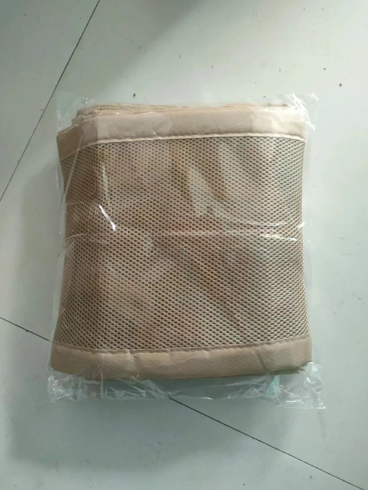 Infant sleeping peacefully in a crib with a breathable mesh bumper for safety