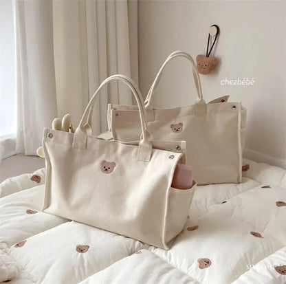 Diaper bag organizer in white canvas, ready for newborn adventures and outings.
