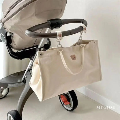 Stylish white canvas bag, functioning as a diaper organizer for new parents.