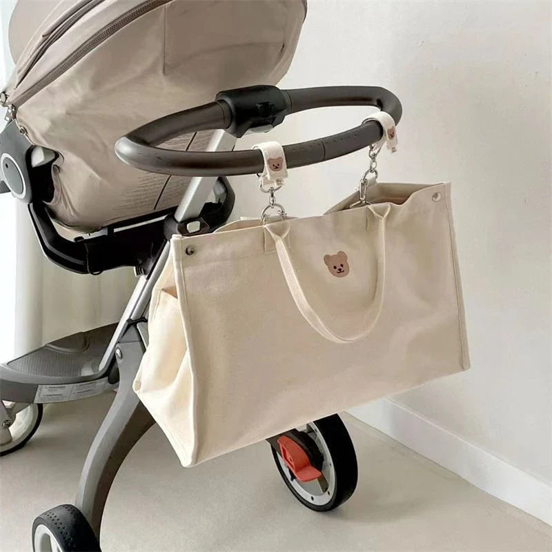 Stylish white canvas mommy bag, perfect for organizing baby essentials on the go.