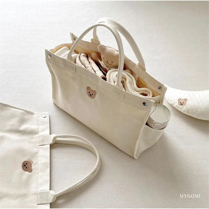 White canvas mommy bag, designed for easy access to all newborn essentials.