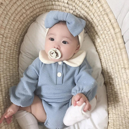 Gender-neutral white baby bodysuit with Peter Pan collar, perfect for any infant