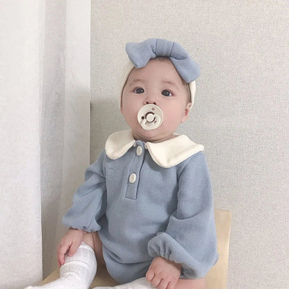 Soft pink infant romper with classic Peter Pan collar, ideal for baby girls