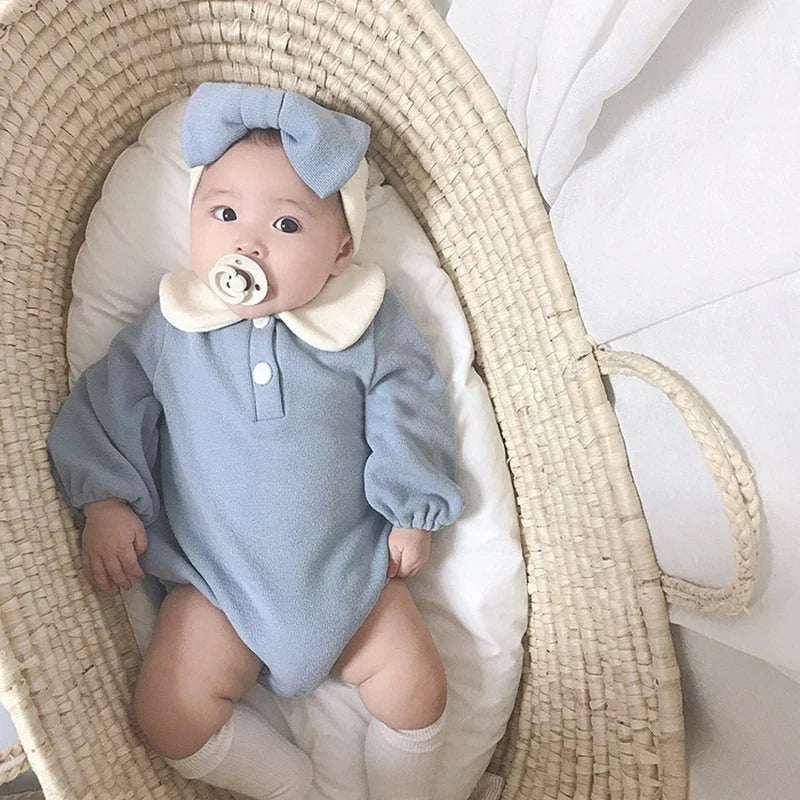 Spring baby outfit: a soft green Peter Pan collar bodysuit for comfort and style