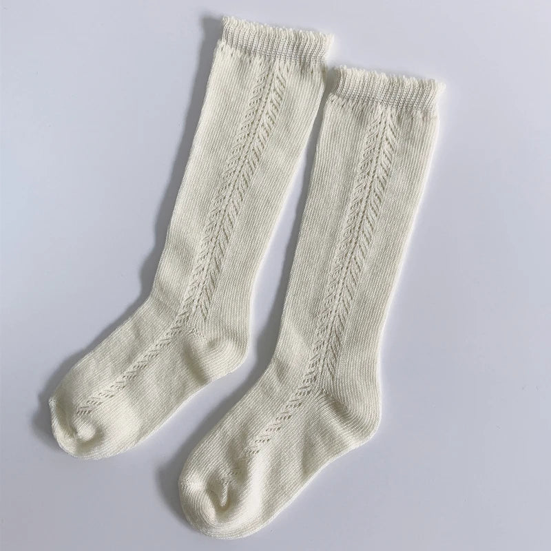 Unisex black cotton knee-high socks for kids, versatile, breathable, all-season apparel