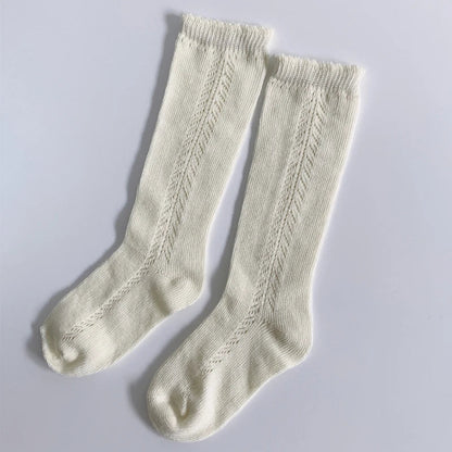 Unisex black cotton knee-high socks for kids, versatile, breathable, all-season apparel