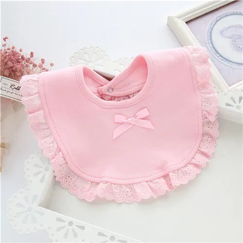Three girls' cotton lace feeding bibs laid out, displaying different stylish lace patterns and soft material.